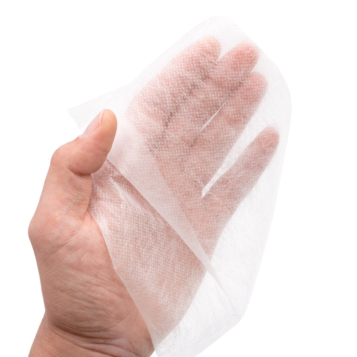 Einzelnes Blatt XKKO ECO-Windelvlies in der Hand, dünn und durchscheinend