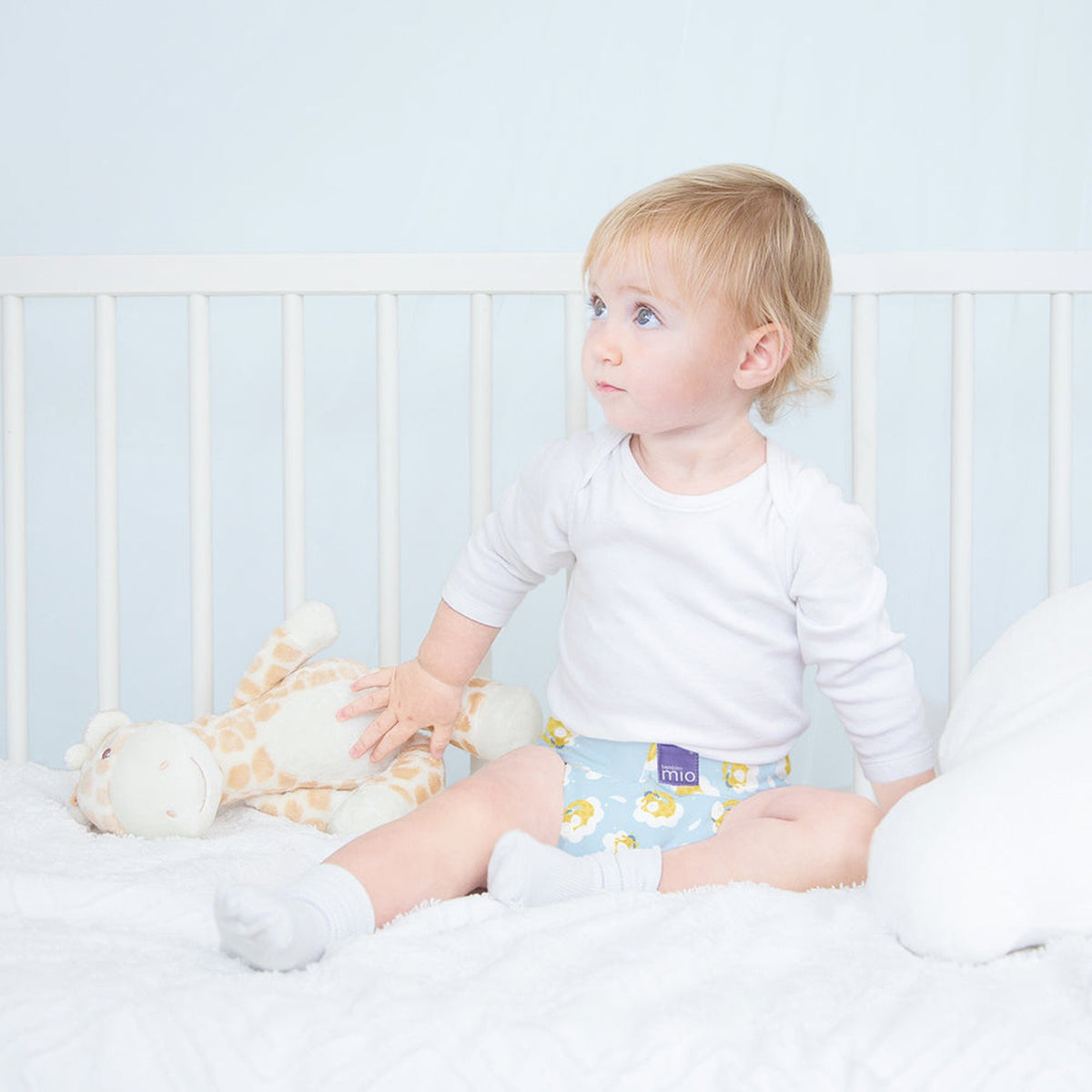 Baby sitzt im Bett in Bambino Mio MioSolo Dreamy Giraffe