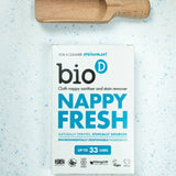 Bio-D Nappy Fresh 500 g mit Holz-Messlöffel auf hellem Untergrund, Hygienepulver für Stoffwindeln