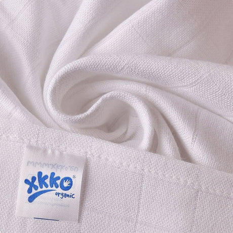 Nahaufnahme einer weißen XKKO Mullwindel 80 x 80 cm mit Logo-Etikett