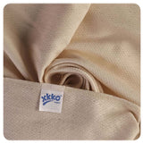 Nahaufnahme der XKKO Birdseye-Mullwindel 50 x 50 cm in Natur mit Logo-Etikett